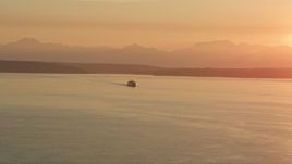 5K aerial stock footage of ferry crossing Elliott Bay at sunset, Washington Aerial Stock Footage | AX50_012
