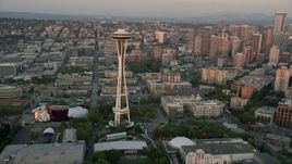 5K aerial stock footage fly over the shore of Elliott Bay to approach and orbit the Space Needle in Downtown Seattle, Washington, sunset Aerial Stock Footage | AX50_020E
