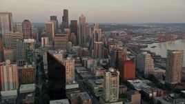 5K aerial stock footage flyby Downtown Seattle skyscrapers to reveal the Central Waterfront piers, Washington, sunset Aerial Stock Footage | AX50_022