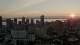 5K aerial stock footage of flying by Downtown Seattle city buildings with Elliott Bay in the background, Washington, sunset Aerial Stock Footage | AX50_026