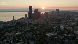 5K aerial stock footage of Downtown Seattle skyscrapers and high-rises in Washington with the setting sun in the background Aerial Stock Footage | AX50_029