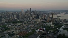 5K aerial stock footage of orbiting around the Seattle Space Needle to reveal skyscrapers in Downtown Seattle, Washington, sunset Aerial Stock Footage | AX50_033