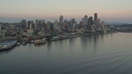 5K aerial stock footage orbit the Space Needle, skyscrapers, and Central Waterfront piers in Downtown Seattle, Washington, sunset Aerial Stock Footage | AX50_034