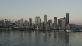 5K aerial stock footage of the Central Waterfront and the Downtown Seattle skyline while flying by ferries sailing Elliott Bay, Washington, sunset Aerial Stock Footage | AX50_035