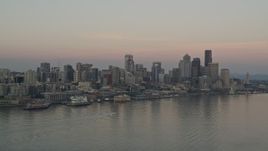 5K aerial stock footage of Central Waterfront and the Downtown Seattle skyline seen from Elliott Bay, Washington, sunset Aerial Stock Footage | AX50_039