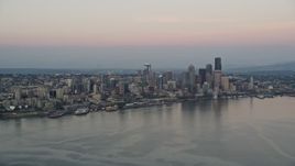 5K aerial stock footage of Central Waterfront and Downtown Seattle skyscrapers seen from Elliott Bay, Washington, sunset Aerial Stock Footage | AX50_042