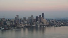 5K aerial stock footage of a view of the Seattle Waterfront and the Downtown Seattle skyline from Elliott Bay in Washington, sunset Aerial Stock Footage | AX50_043