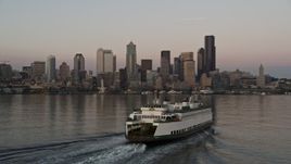 5K aerial stock footage track a ferry sailing Elliott Bay and reveal the Central Waterfront and the Downtown Seattle skyline, Washington, sunset Aerial Stock Footage | AX50_046