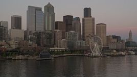 5K aerial stock footage of low approach to the Great Wheel and Waterfront, and the towering skyline of Downtown Seattle, Washington, sunset Aerial Stock Footage | AX50_049E