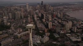 5K aerial stock footage orbit the Space Needle, tilt to reveal Downtown Seattle skyscrapers, Washington, sunset Aerial Stock Footage | AX50_055