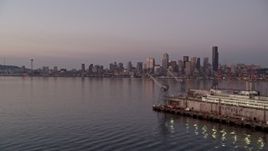 5K aerial stock footage flyby dry docks at Harbor Island to focus on the Downtown Seattle skyline across Elliott Bay, Washington, sunset Aerial Stock Footage | AX50_071