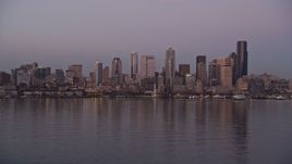 5K aerial stock footage of a view across Elliott Bay at the Downtown Seattle skyline and Central Waterfront, Washington, sunset Aerial Stock Footage | AX50_072