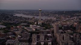 5K aerial stock footage tilt from Elliott Bay to reveal the Seattle Space Needle and Central Waterfront piers in Downtown Seattle, Washington, sunset Aerial Stock Footage | AX50_073E