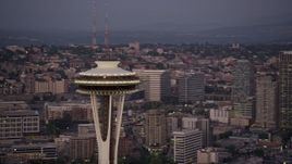 5K aerial stock footage of the Space Needle, with Elliott Bay, neighborhoods, lake and downtown in the background, Downtown Seattle, Washington, sunset Aerial Stock Footage | AX50_077E