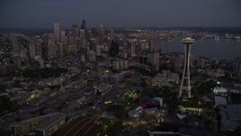 5K aerial stock footage of a view of Downtown Seattle's tall skyscrapers seen while flying by the Space Needle, Washington, twilight Aerial Stock Footage | AX50_090