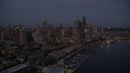 5K aerial stock footage of passing the Downtown Seattle skyline, Central Waterfront piers and Seattle Great Wheel, Washington, twilight Aerial Stock Footage | AX50_091E