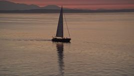 5K aerial stock footage video of sailboat on Elliott Bay at sunset, Seattle, Washington Aerial Stock Footage | AX50_094