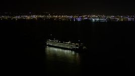 5K aerial stock footage track a ferry sailing Elliott Bay and reveal Downtown Seattle skyline, Washington, night Aerial Stock Footage | AX51_011