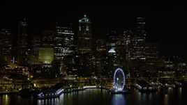 5K aerial stock footage of low approach to Seattle Great Wheel and Waterfront, and Downtown Seattle skyline, Washington, night Aerial Stock Footage | AX51_013E