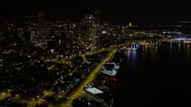 5K aerial stock footage tilt from Pier 70 to reveal Waterfront and Downtown Seattle skyscrapers, Washington, night Aerial Stock Footage | AX51_024E