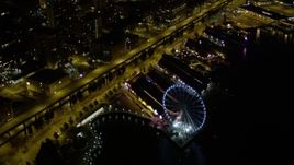 5K aerial stock footage flyby Downtown Seattle skyscrapers to reveal and orbit the Seattle Great Wheel at night, Washington Aerial Stock Footage | AX51_039E