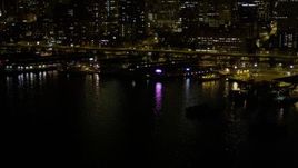 5K aerial stock footage of Central Waterfront piers near Seattle Great Wheel in Downtown Seattle, Washington, night Aerial Stock Footage | AX51_043E