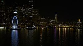 5K aerial stock footage approach Central Waterfront piers near the Seattle Great Wheel at night, Downtown Seattle, Washington Aerial Stock Footage | AX51_046E