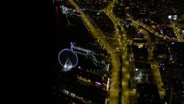 5K aerial stock footage orbit the Seattle Great Wheel, Central Waterfront piers, and Alaskan Way Viaduct in Downtown Seattle, Washington, night Aerial Stock Footage | AX51_071