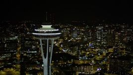 5K aerial stock footage orbit top of the Space Needle to reveal and focus on Downtown Seattle skyscrapers, Washington, night Aerial Stock Footage | AX51_074E