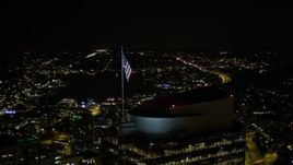 5K aerial stock footage orbit the American flag atop Two Union Square in Downtown Seattle, Washington, night Aerial Stock Footage | AX51_078E