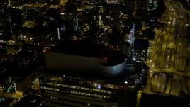 5K aerial stock footage track American flag on Two Union Square rooftop, Downtown Seattle, Washington, night Aerial Stock Footage | AX51_090