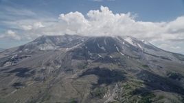 5K aerial stock footage approach cloud-capped Mount St. Helens with patches of snow, Washington Aerial Stock Footage | AX52_046