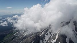 5K aerial stock footage tilt up the snowy slope of Mount St. Helens with summit clouds, Washington Aerial Stock Footage | AX52_055