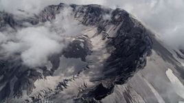 5K aerial stock footage pan across and flyby the Mount St. Helens crater and clouds, Washington Aerial Stock Footage | AX52_064