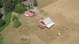 5K aerial stock footage flyby and approach a red barn by farm fields in La Center, Washington Aerial Stock Footage | AX52_074E