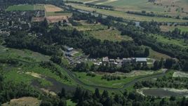 5K aerial stock footage approach and tilt to a water treatment plant beside a river in Ridgefield, Washington Aerial Stock Footage | AX52_092