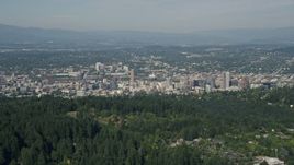 5K aerial stock footage fly over wooded hills toward city buildings, Downtown Portland, Oregon Aerial Stock Footage | AX53_012E