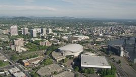 5K aerial stock footage tilt from Moda Center revealing downtown and Willamette River, Downtown Portland, Oregon Aerial Stock Footage | AX53_037E