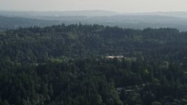 5K aerial stock footage fly over tree covered hills, approach Portland Children's Museum, Southwest Portland, Oregon Aerial Stock Footage | AX53_087