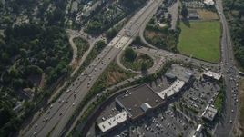 5K aerial stock footage fly over shopping center and tilt to bird's eye of light traffic on highway, Southwest Portland, Oregon Aerial Stock Footage | AX53_095