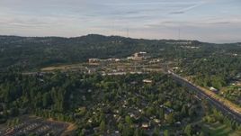 5K aerial stock footage of Providence St. Vincent Medical Center, highway interchange, Southwest Portland, Oregon, sunset Aerial Stock Footage | AX54_009E