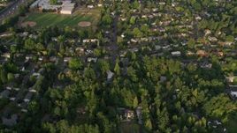 5K aerial stock footage bird's eye view of neighborhoods, revealing a school, Southwest Portland, Oregon, sunset Aerial Stock Footage | AX54_011