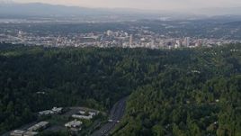 5K aerial stock footage of flying over Highway 26, tilt up to Downtown Portland, Oregon, sunset Aerial Stock Footage | AX54_014