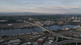 5K aerial stock footage of flying by the Fremont Bridge, spanning Willamette River, Downtown Portland, Oregon, sunset Aerial Stock Footage | AX54_021E