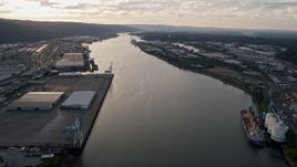 5K aerial stock footage of riverfront warehouses by the Willamette River, Northwest Industrial, Portland, Oregon, sunset Aerial Stock Footage | AX54_023