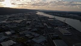 5K aerial stock footage fly over Northwest Industrial, approach Willamette River, Portland, Oregon, sunset Aerial Stock Footage | AX54_026