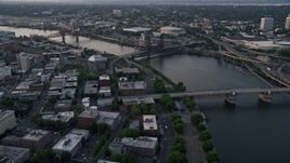 5K aerial stock footage of flying by bridges spanning the Willamette River near Memorial Coliseum and Moda Center, Downtown Portland, Oregon, sunset Aerial Stock Footage | AX54_044