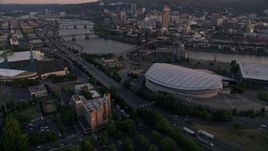 5K aerial stock footage approach and fly over Rose Garden Arena, Steel Bridge, Downtown Portland, Oregon, sunset Aerial Stock Footage | AX54_074E