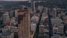 5K aerial stock footage of flying by US Bancorp Tower and city streets in Downtown Portland, Oregon, sunset Aerial Stock Footage | AX54_076