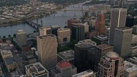 5K aerial stock footage of approaching office building and Terry Schrunk Plaza and tilt down Downtown Portland, Oregon, sunset Aerial Stock Footage | AX54_088